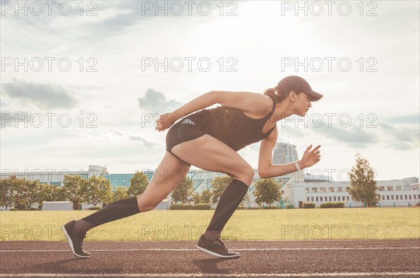 Professional runner stands on the track and prepares for the start of the race. Sports concept.