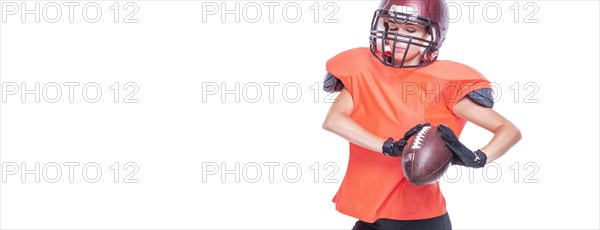 Woman in the uniform of an American football team player catches the ball. White background. Sports concept.