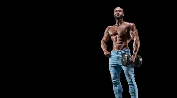 Isolated muscular man on a black background. Bodybuilding and fitness concept. Panorama.