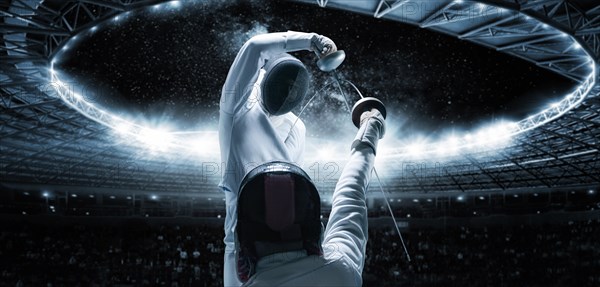 Portrait of two fencers against the backdrop of a sports arena. The concept of fencing. Duel.