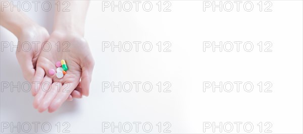 Image of pills on a female palm. The concept of medicine