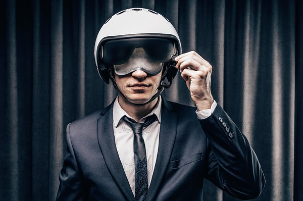 Elegant steward is standing in the cockpit in a helmet. The concept of safe flights. Insurance.