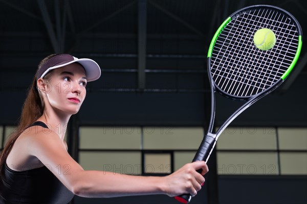 Portrait of a beautiful tennis player training on the court. Sports concept.