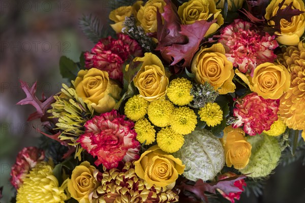 Funeral wreath with flowers at a grave