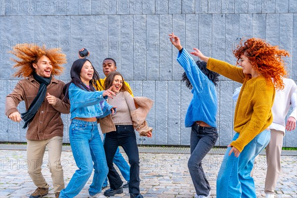 Multi-ethnic happy friends dancing excited in the city together