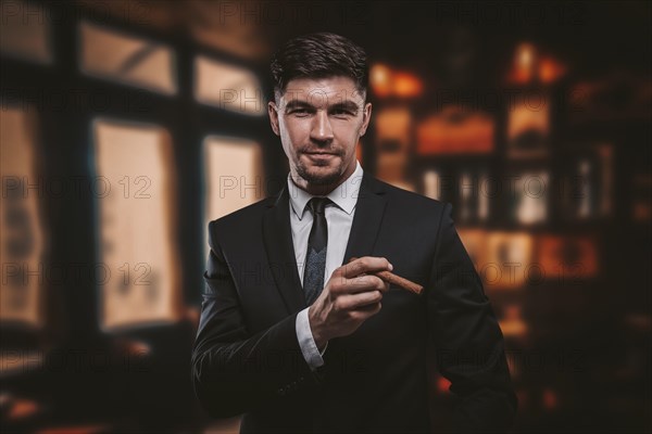 Portrait of a stylish man in a suit with a cigar. Business concept.