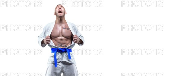 Professional athlete in a kimono screams emotionally. The concept of karate and judo competitions.