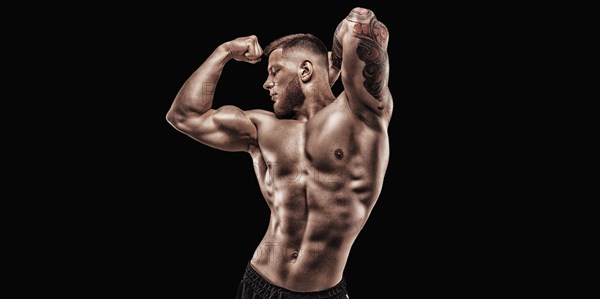 Young muscular guy posing in the studio. Fitness and nutrition concept.