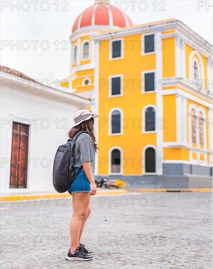 Young tourist with a backpack in a tourist plaza in Granada