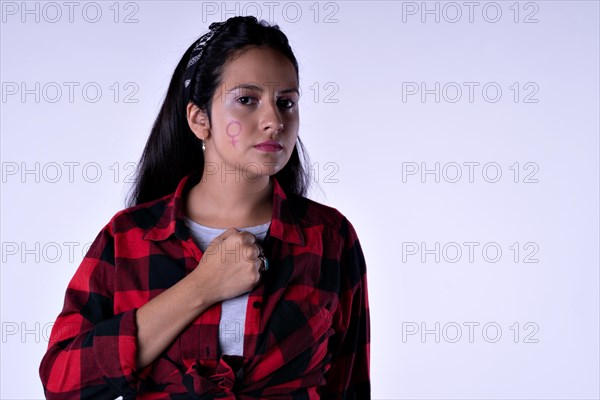 Portrait of serious latina woman. Concept of feminism. Portrait in studio