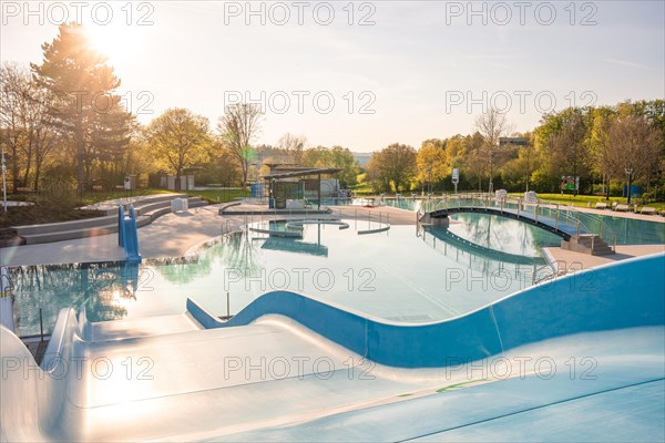 Impressive drone view of a swimming pool surrounded by fog in the first sunlight