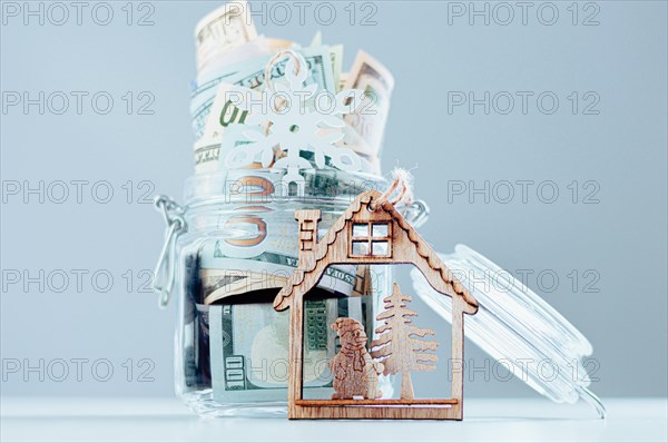 Glass piggy bank full of money. Christmas and New Year concept. Gift expenses.