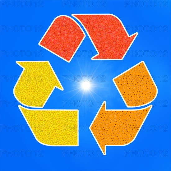 The universal recycling symbol. It is an internationally recognized symbol for recycling. Against blue sky and with the sun