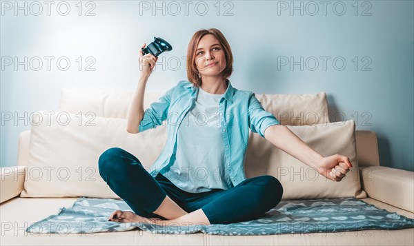 Girl with a joystick in her hands rejoices in victory. ESports concept.