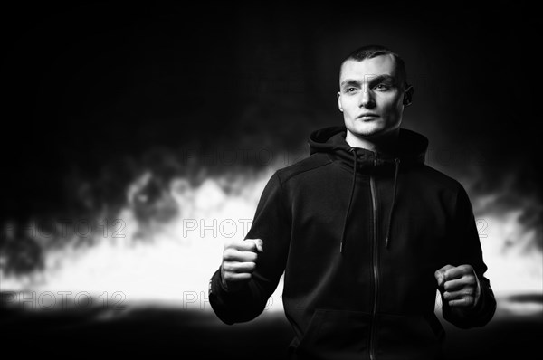 Young kickboxer posing in the studio. The concept of martial arts