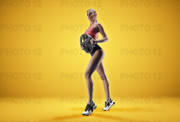 Delightful athlete posing in the studio with weights in her hands. The concept of sports