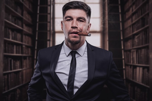 Portrait of a stylish man in a suit with a cigar. Business concept.