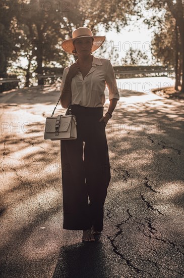 Portrait of a charming girl walking in a park in Florence. The concept of tourism