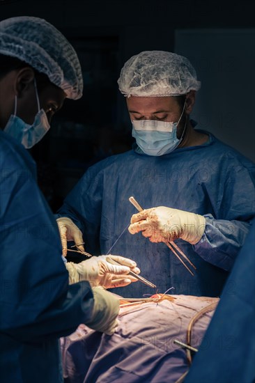 Male Surgeons in the operation room during a procedure. Hospital surgery