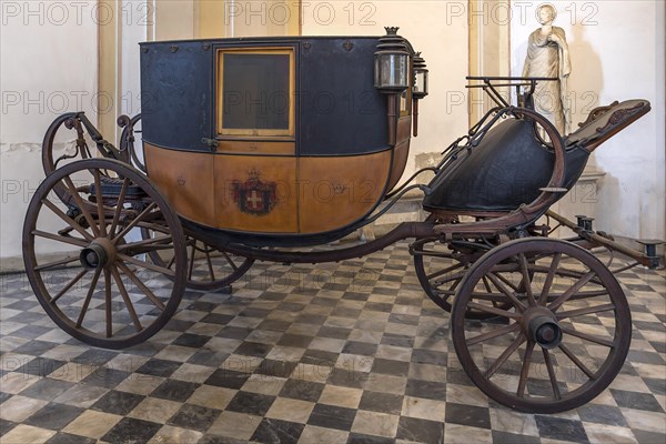 Historic horse-drawn carriage in the vestibule of the former royal palace