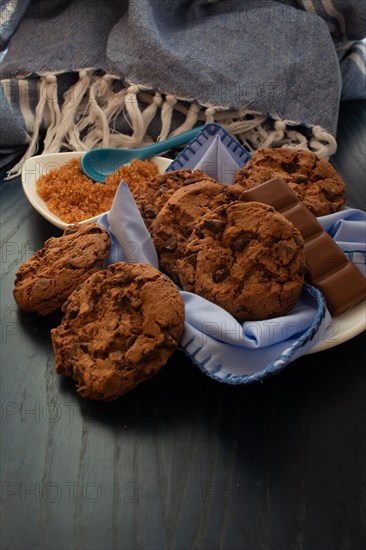 A comforting set of chocolate chip cookies next to brown sugar