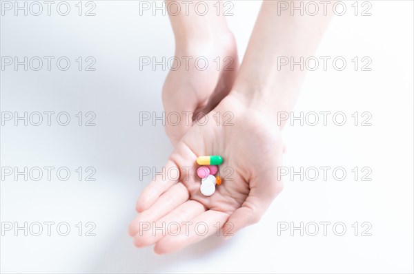 Image of pills on a female palm. The concept of medicine