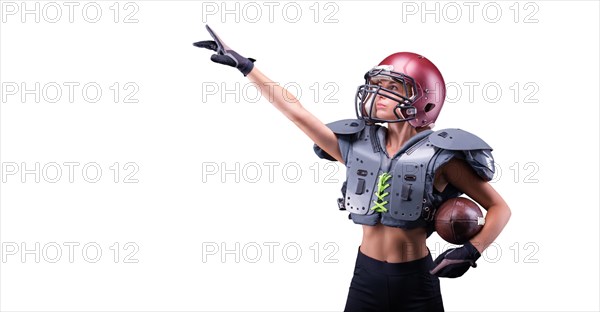 Woman in the uniform of an American football team player points with a finger to the empty space. Sports concept.