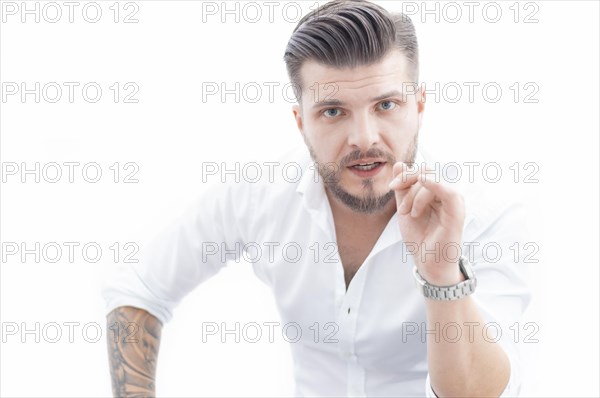 Confident man in a shirt looks at the camera and instructs a potential employee. The concept of mentoring