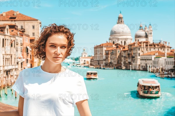 Portrait of a charming girl with a view of santa maria della salute. Travel and vacation concept.