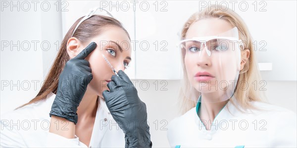 Portrait of two girls in white coats. The concept of cosmetology