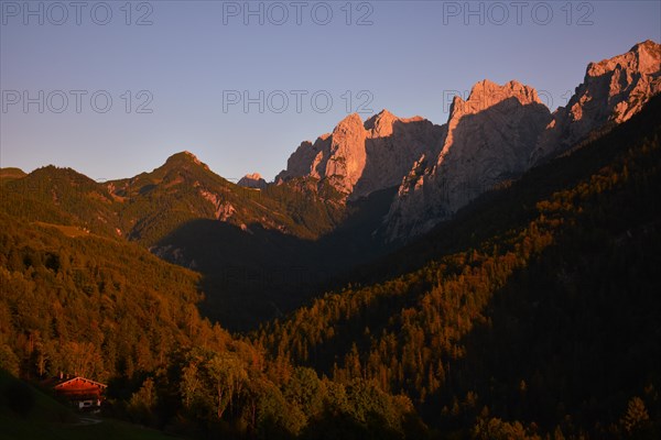 The last rays of sunlight illuminate the peaks of the Wilder Kaiser