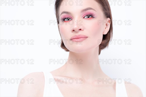 Portrait of a beautiful girl with provocative makeup. White background. Beauty concept. High quality