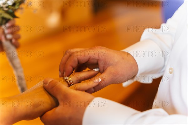 Man putting the ring on the bride at a wedding