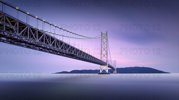 Long exposure of a colourful dusk at the illuminated Akashi Kaikyo Bridge