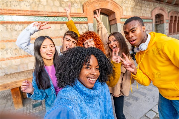 African girl and diverse friends taking a selfie in the city