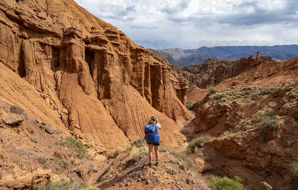 Climber in a canyon with a dry stream bed