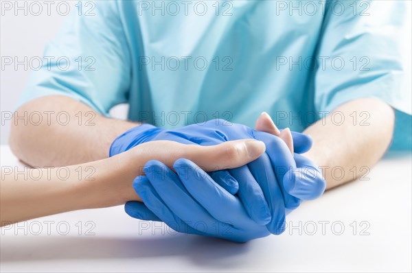 The doctor carefully picked up the patient's hand. Medical concept. Insurance.