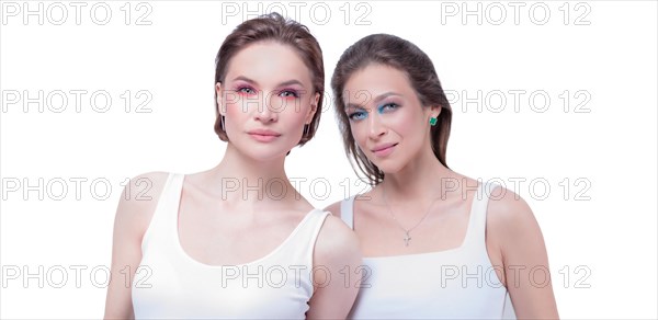 Portrait of two beautiful girls with defiant make-up on a white background. Female friendship concept. High quality