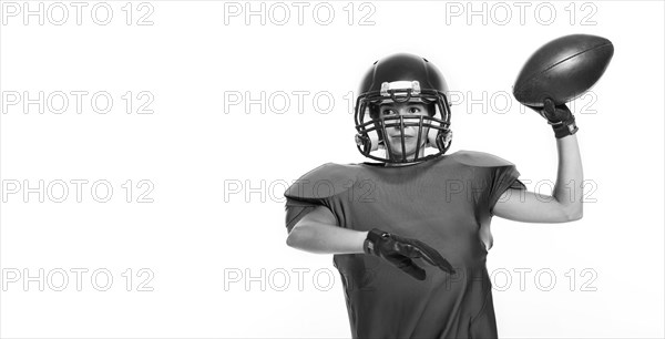 Black and white images of a sports girl in the uniform of an American football team player. Sports concept. White background.