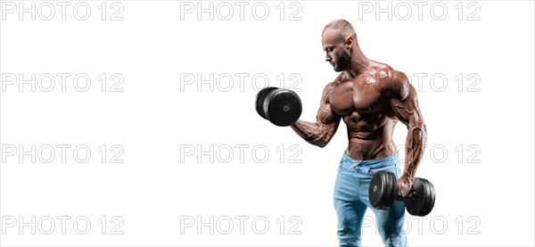 The athlete performs an exercise in the gym with dumbbells on a white background. Fitness