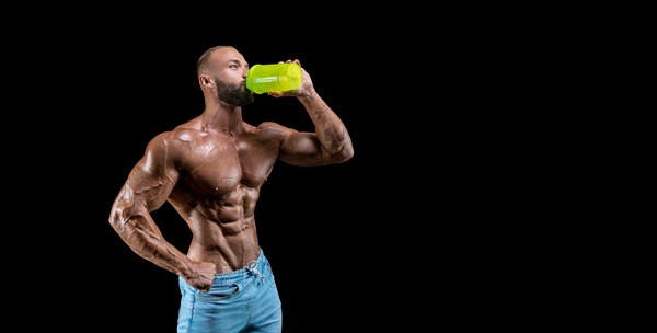 Isolated muscular man on a black background. Bodybuilding and fitness concept. Panorama.