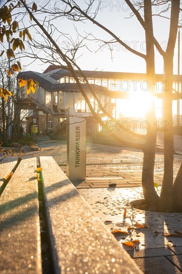 Drinking water tap in the park during an autumn sunset