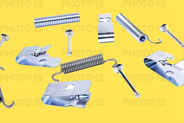 Parking brake springs and clamps repair kit on yellow isolated background