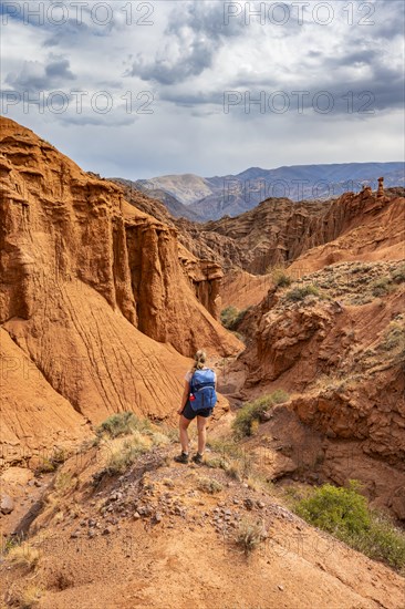 Climber in a canyon with a dry stream bed