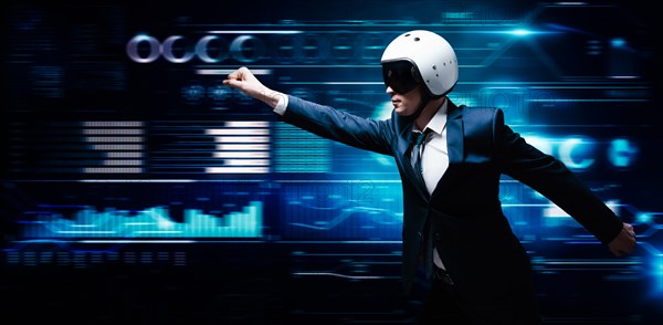 Portrait of a man in a suit and helmet. He shows that he is flying against the background of a hologram of market trading. Business concept. Stock market. Brokers and traders.