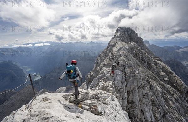 Climber on a via ferrata secured with steel rope