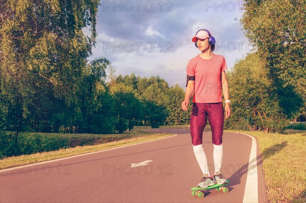 Image of a girl riding a skateboard in the park. Sports concept.