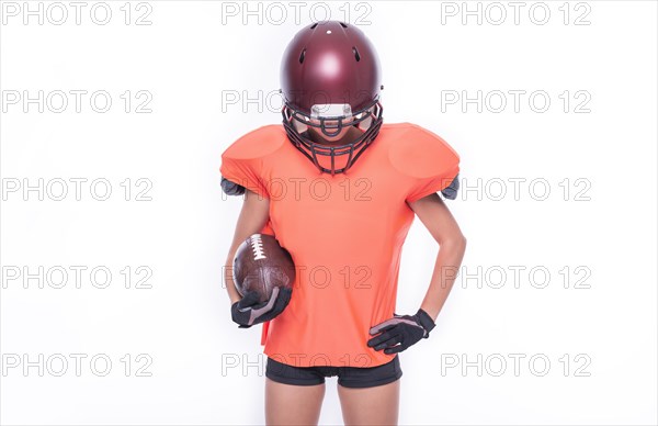 Woman in the uniform of an American football team player posing with a ball on a white background. Sports concept.