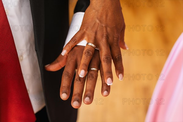 Black ethnic couple embracing with ring at a beautiful wedding