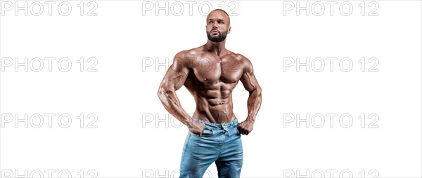 Sportsman posing on a white background in jeans. Fitness